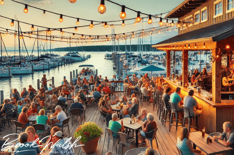 Scenic waterfront dining at a Traverse City restaurant overlooking Grand Traverse Bay during sunset.